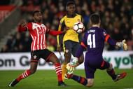 SOUTHAMPTON, ENGLAND - JANUARY 28:  Danny Welbeck of Arsenal chips Harry Lewis of Southampton to score his sides first goal during the Emirates FA Cup Fourth Round match between Southampton and Arsenal at St Mary's Stadium on January 28, 2017 in Southampton, England.  (Photo by Julian Finney/Getty Images)